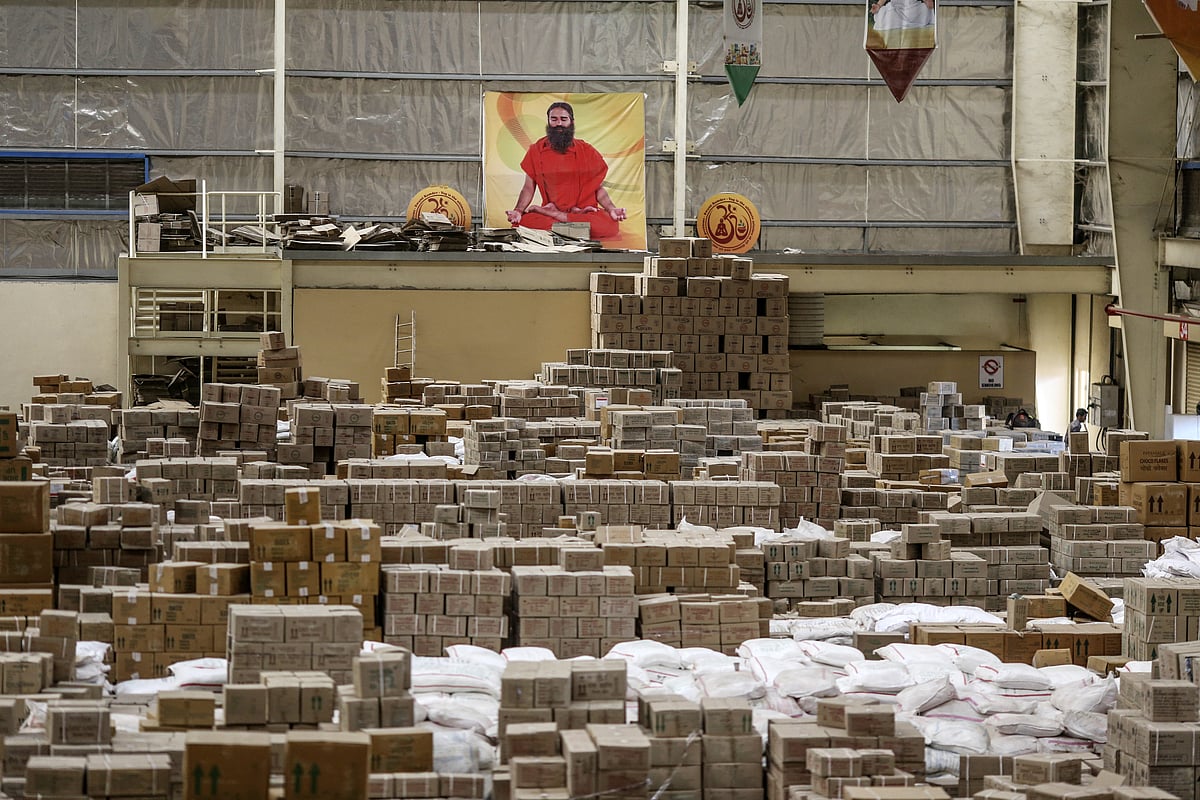 A poster depicting yoga guru Baba Ramdev is displayed inside a warehouse operated by Patanjali Ayurved Ltd. near to the Multi-modal International Cargo Hub Airport at Nagpur (MIHAN) in Nagpur. (Photographer: Dhiraj Singh/Bloomberg) &nbsp;
