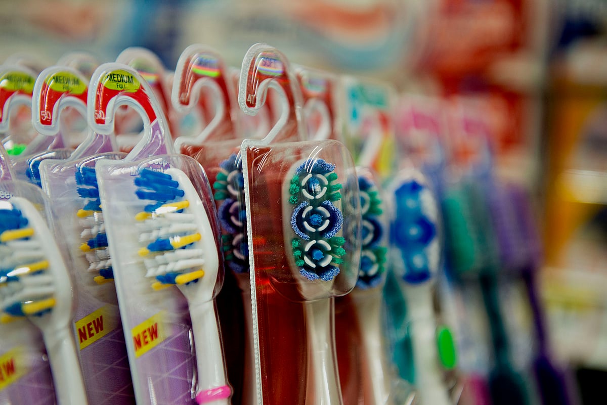 Tooth brushes sit on display for sale in a supermarket. (Photographer: Daniel Acker/Bloomberg)