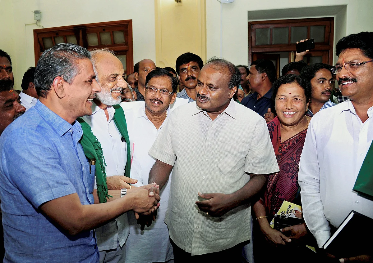 Karnataka Chief Minister HD Kumaraswamy and his deputy G Parameshwara before a meeting with farmer associations at the Vidhana Soudha in Bengaluru on Wednesday.(Source:PTI)