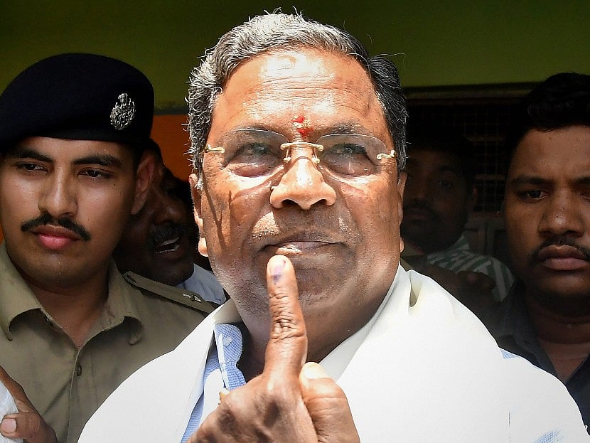 Karnataka Chief Minister Siddaramaiah shows his ink stained finger after voting in the Karnataka Assembly elections 2018, at Hundi village in Mysore on Saturday. (Source: PTI)