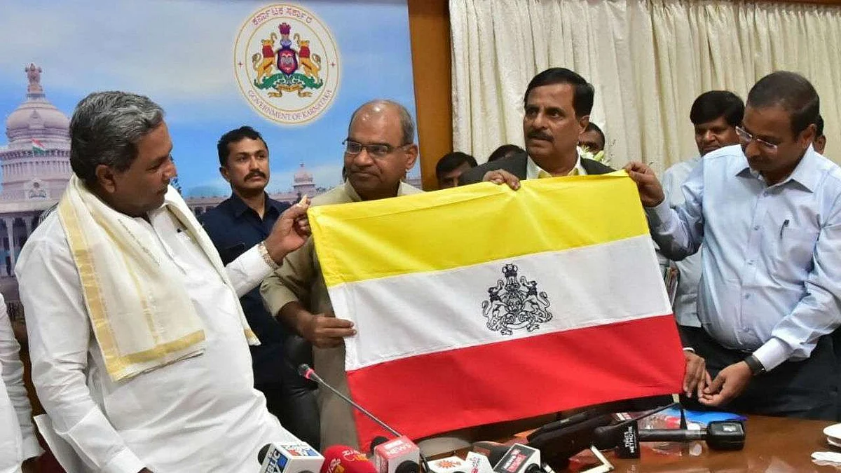 Chief Minister Sidaramaiah unveils the Karnataka flag. (Source: Twitter/INC).
