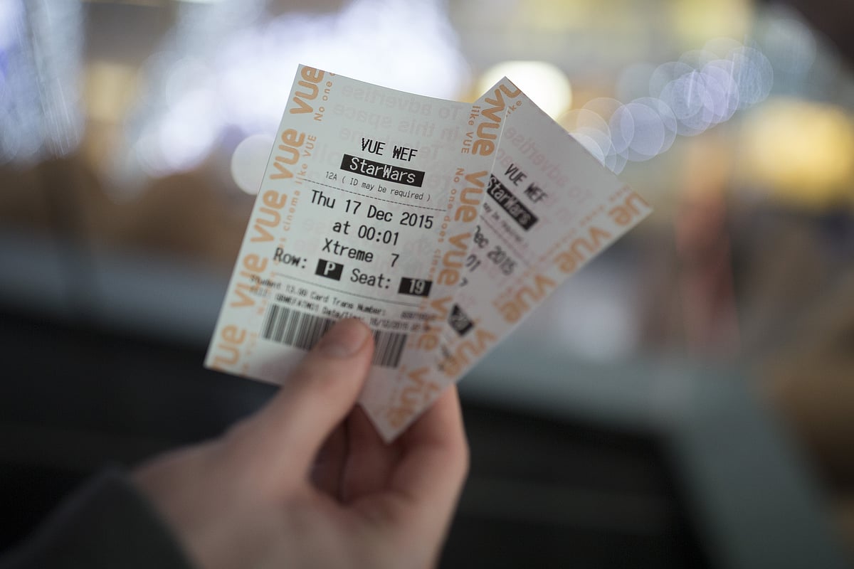 A customer holds his tickets to view the first public screening of Walt Disney’s “Star Wars: The Force Awakens” on Dec. 16, 2015. (Photographer: Simon Dawson/Bloomberg)