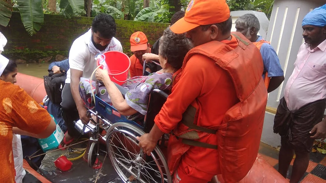 NDRF rescues a wheelchair-bound senior citizen in Kerala. (Source: NDRF’s Official Twitter Page)
