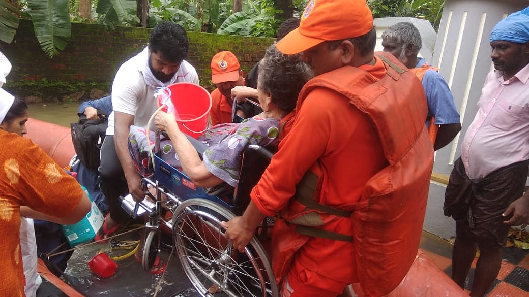 NDRF rescues a wheelchair-bound senior citizen in Kerala. (Source: NDRF’s Official Twitter Page)