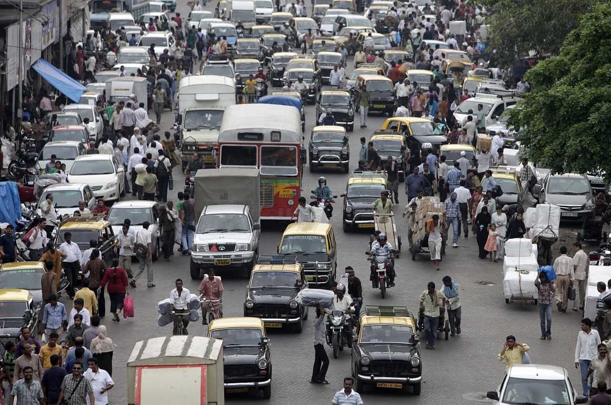 Cars, pedestrians, carts and motorcycles move down a congested street in Mumbai. (Photographer: Kuni Takahashi/Bloomberg)