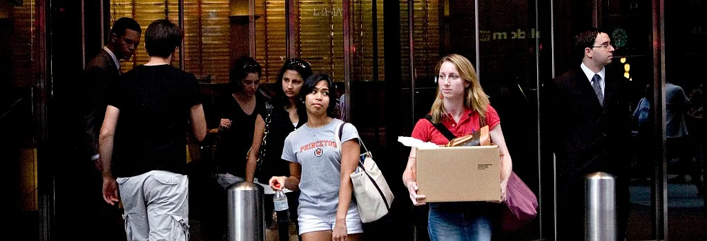 A woman carries a box as she leaves the headquarters of Lehman Brothers in New York, ahead of its bankruptcy filing, on Sept. 14, 2008. (Photographer: Tom Starkweather/Bloomberg News)