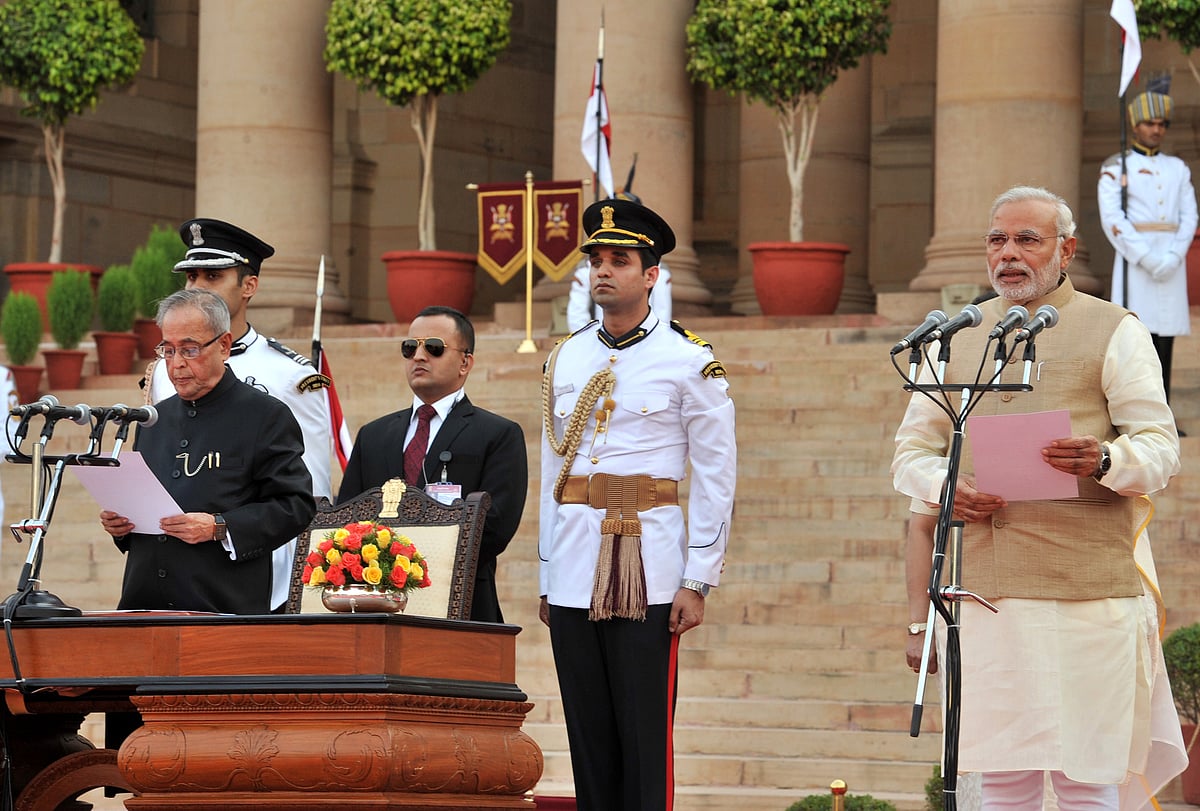 President Pranab Mukherjee administers the oath of office of Prime Minister to Narendra Modi,  in New Delhi, on May 26, 2014. (Photograph: PIB)<a href="https://www.facebook.com/sharer/sharer.php?u=http://pibphoto.nic.in/photo//2014/May/l2014052653989.jpg"><i><br></i></a>
