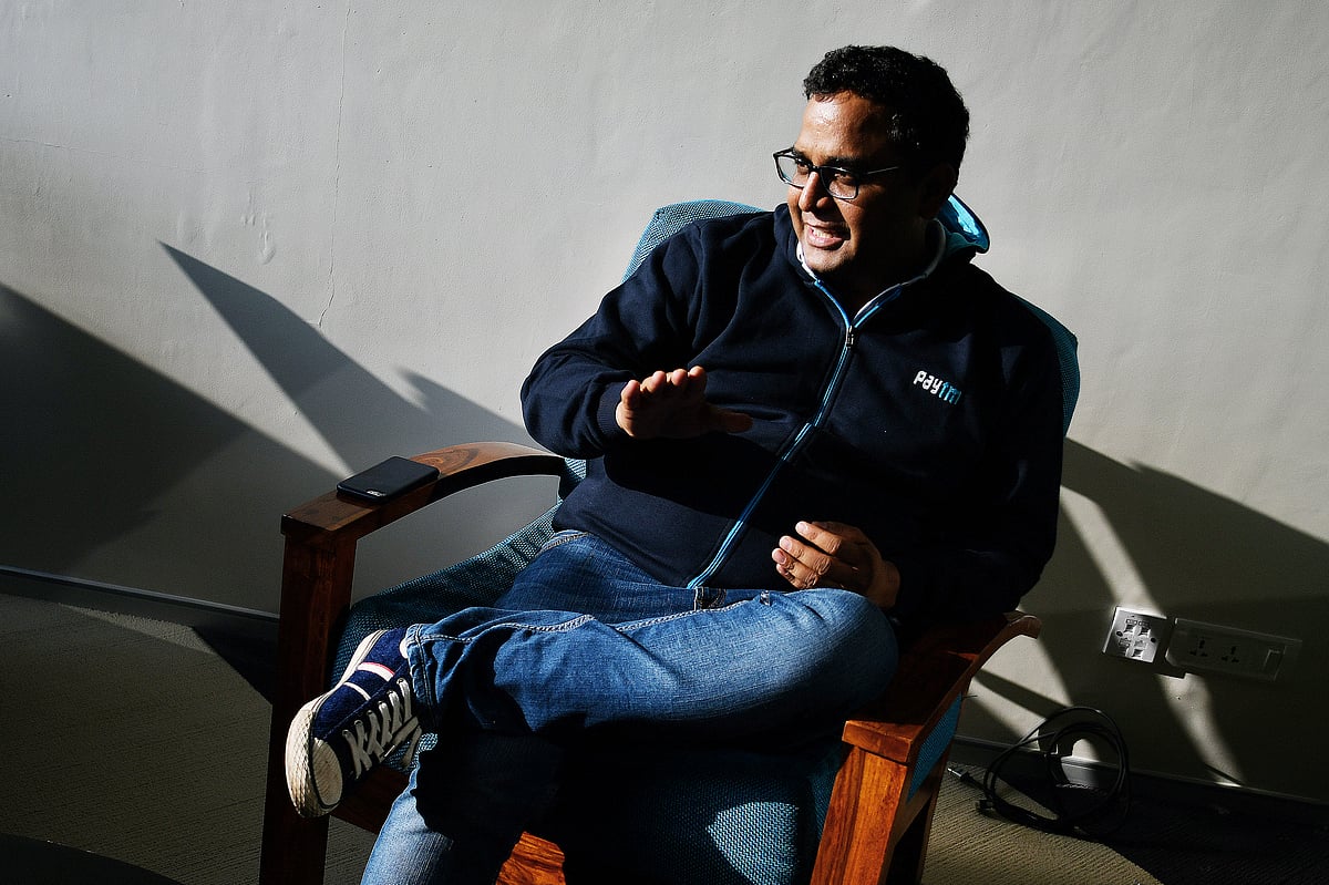 Vijay Shekhar Sharma, founder and chairman of One97 Communications Ltd., operator of PayTM, left, talks during a meeting at the company’s office in Noida, Uttar Pradesh, India. (Photographer: Anindito Mukherjee/Bloomberg)