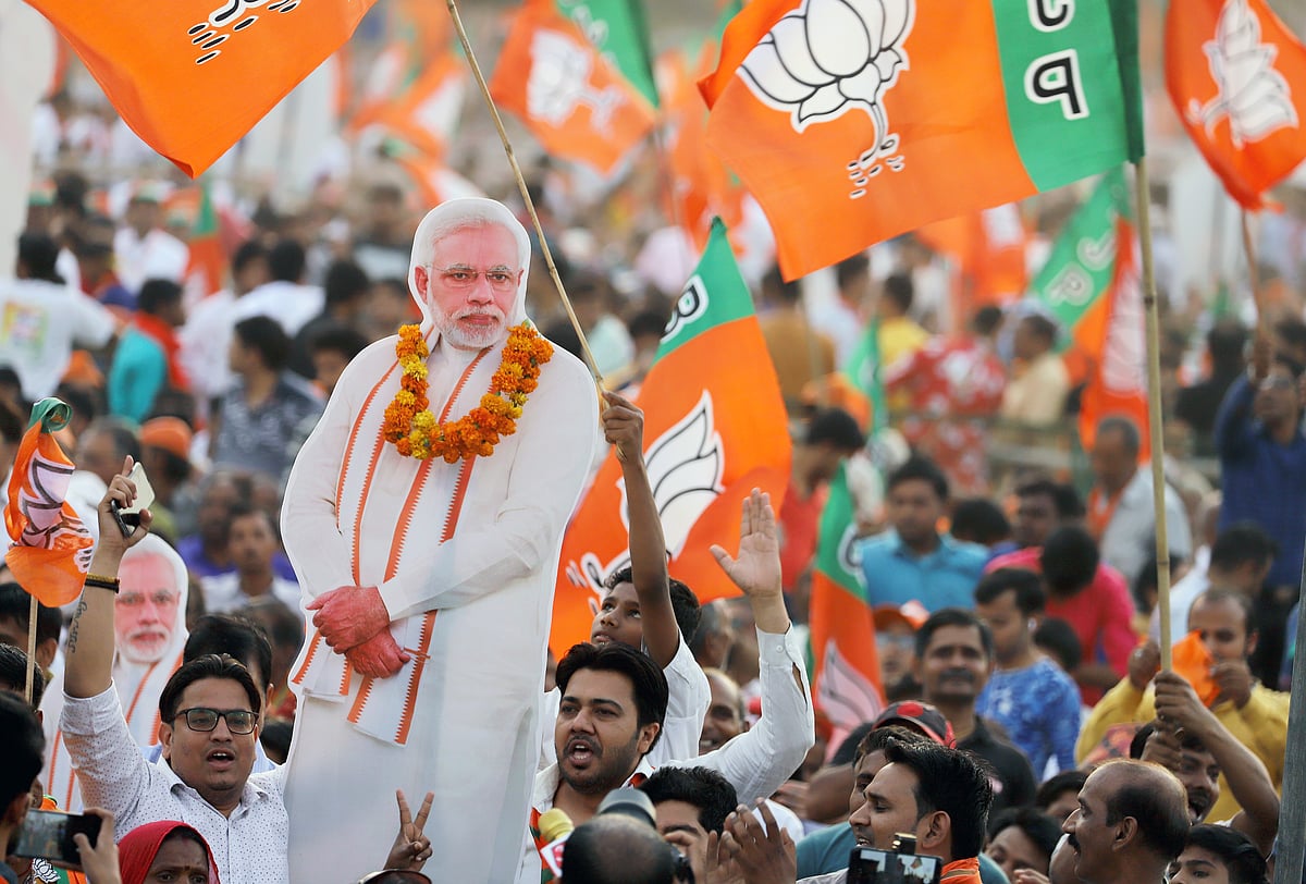 BJP supporters hold up a cardboard cutout of Prime Minister Narendra Modi at a rally in New Delhi, on May 8, 2019. (Photographer: Anindito Mukherjee/Bloomberg)