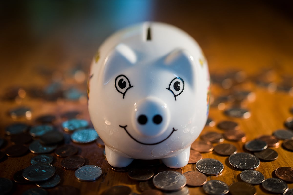 Coins surround a piggy bank in this arranged photograph. (Photographer: Ron Antonelli/Bloomberg)