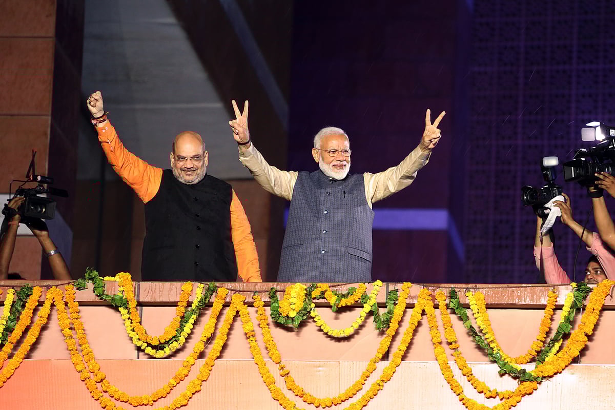 Narendra Modi, India’s prime minister, right, and Amit Shah, president of the Bhartiya Janata Party (BJP), celebrate during an event at the party’s headquarters in New Delhi, India. (Photographer: T. Narayan/Bloomberg)
