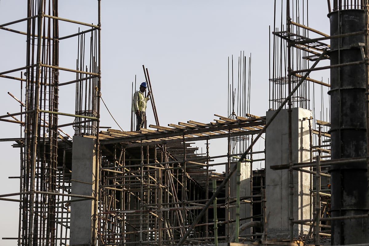 A laborer works at a construction site on the outskirts of Mumbai. (Photographer: Dhiraj Singh/Bloomberg)
