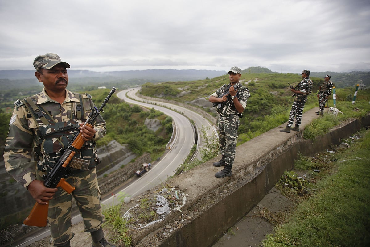 CRPF personnel stand guard on Jammu-Srinagar national highway on the eve of  73rd Independence Day celebrations, in Jammu. (Source: PTI)