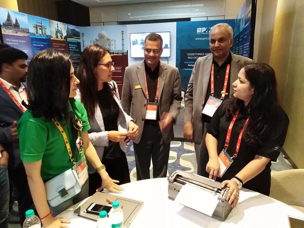 Nidhi Arora (right) sharing Braille with the Robinhood Army team at the PMI National Conference, 2018. (Photo: Esha)