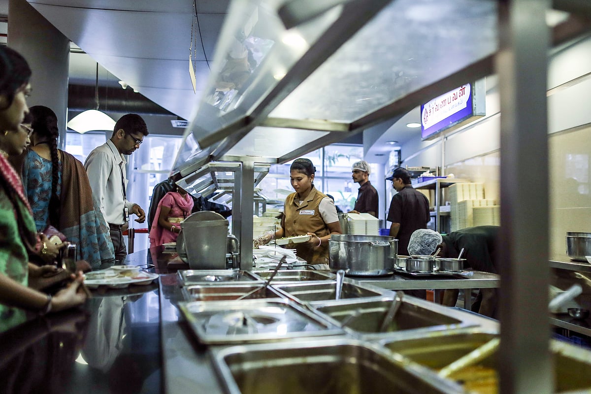 A worker serves food in the canteen at the Tata Consultancy Services Ltd. (TCS) campus. (Photographer: Dhiraj Singh/Bloomberg)