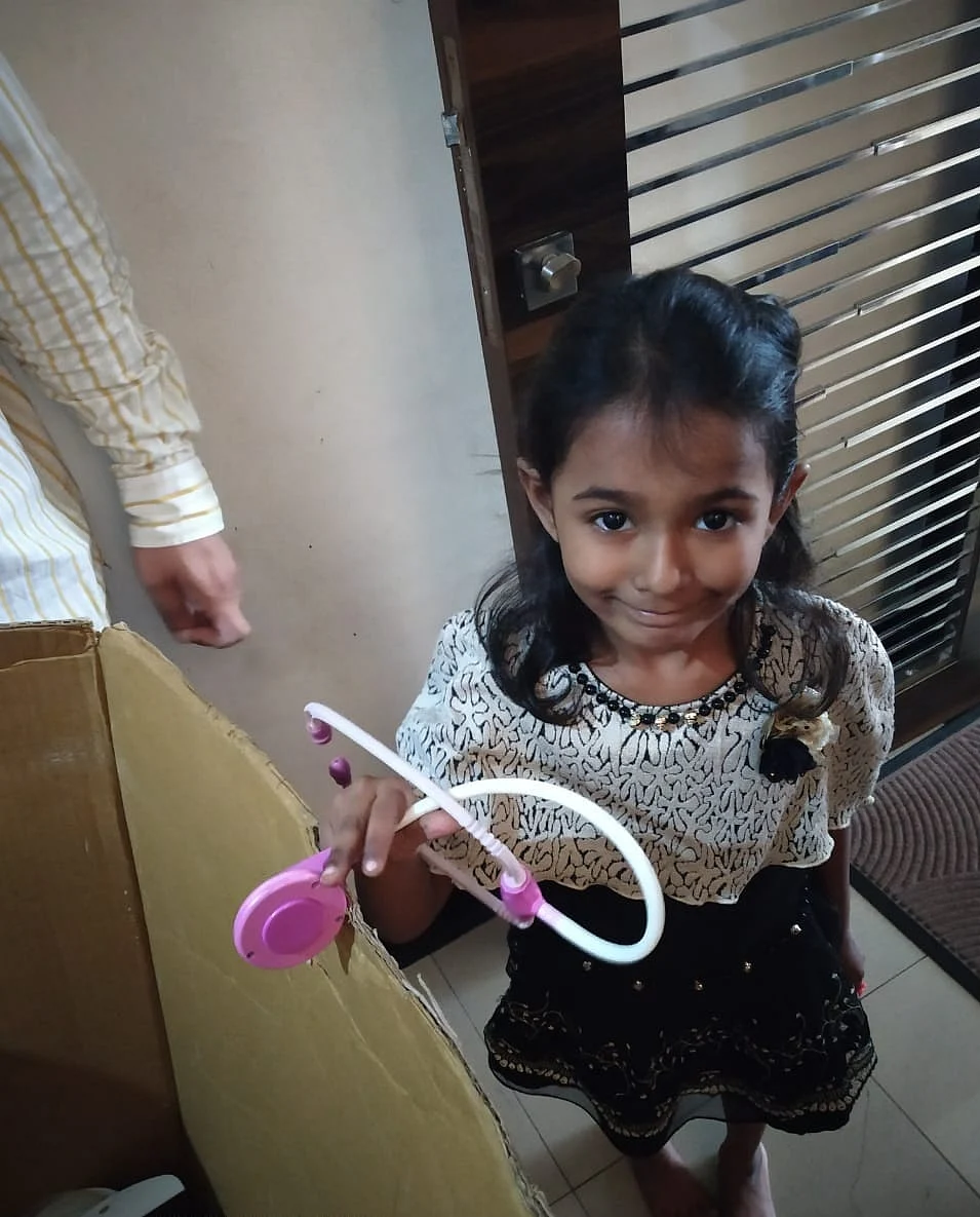 A young girl sacrifices her toy she grew up with. (Photograph: Shishir Joshi)
