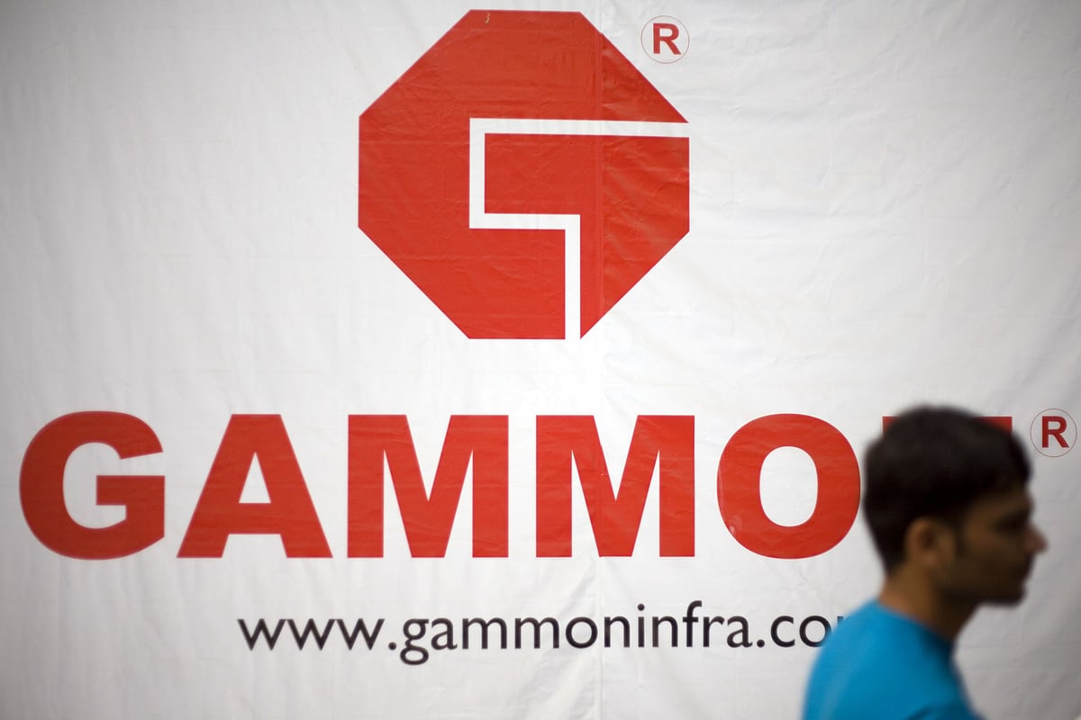 A man walks past Gammon India’s corporate head office in Mumbai, India. (Photographer: Prashanth Vishwanathan/Bloomberg News)