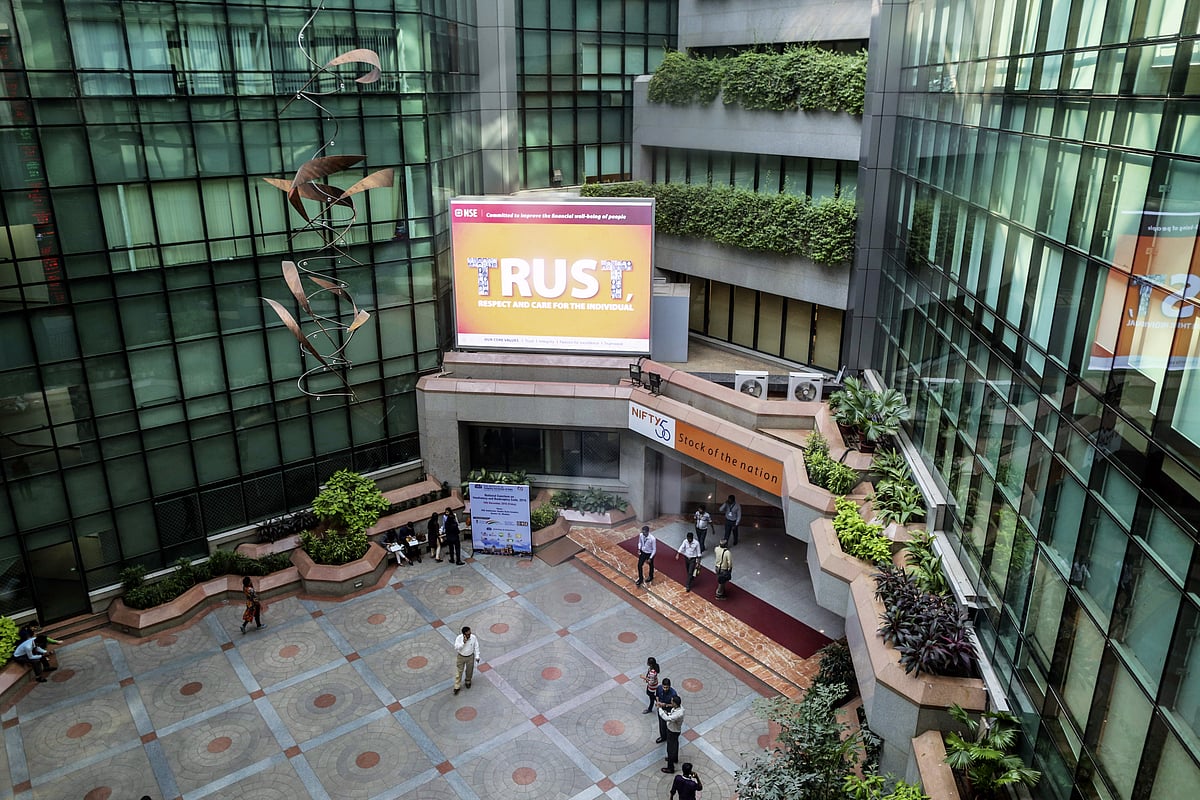 Employees walk through the atrium of the National Stock Exchange of India Ltd. (NSE) building in Mumbai. (Photographer: Dhiraj Singh/Bloomberg)
