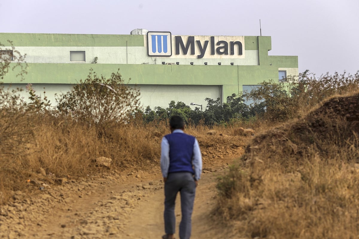 A pedestrian walks along a track near the Mylan Laboratories Ltd. factory in India. (Photographer: Dhiraj Singh/Bloomberg) &nbsp;