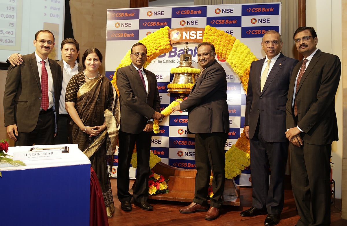 CSB Bank CEO CVR Rajendran, fourth from left, rings a bell to mark the stock’s market debut at the National Stock Exchange in Mumbai, India, on Dec. 4, 2019. (Photo: CSB Bank)