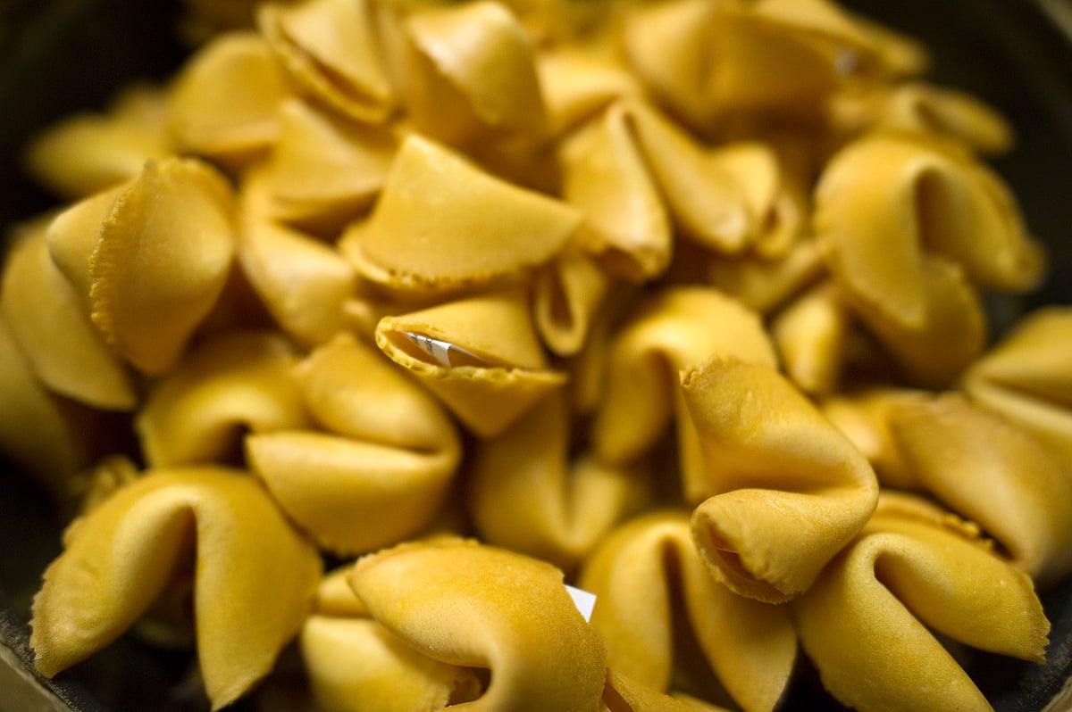 Newly made fortune cookies cool in a bucket at a factory in San Francisco, California, U.S. (Photographer: David Paul Morris/Bloomberg)