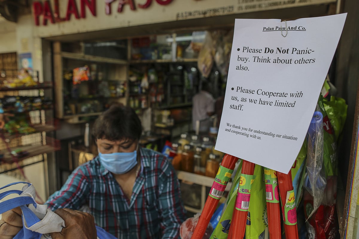 A sign advises customers not to panic buy goods outside grocery store in Mumbai, India, on Wednesday, March 25, 2020. (Photographer: Dhiraj Singh/Bloomberg)