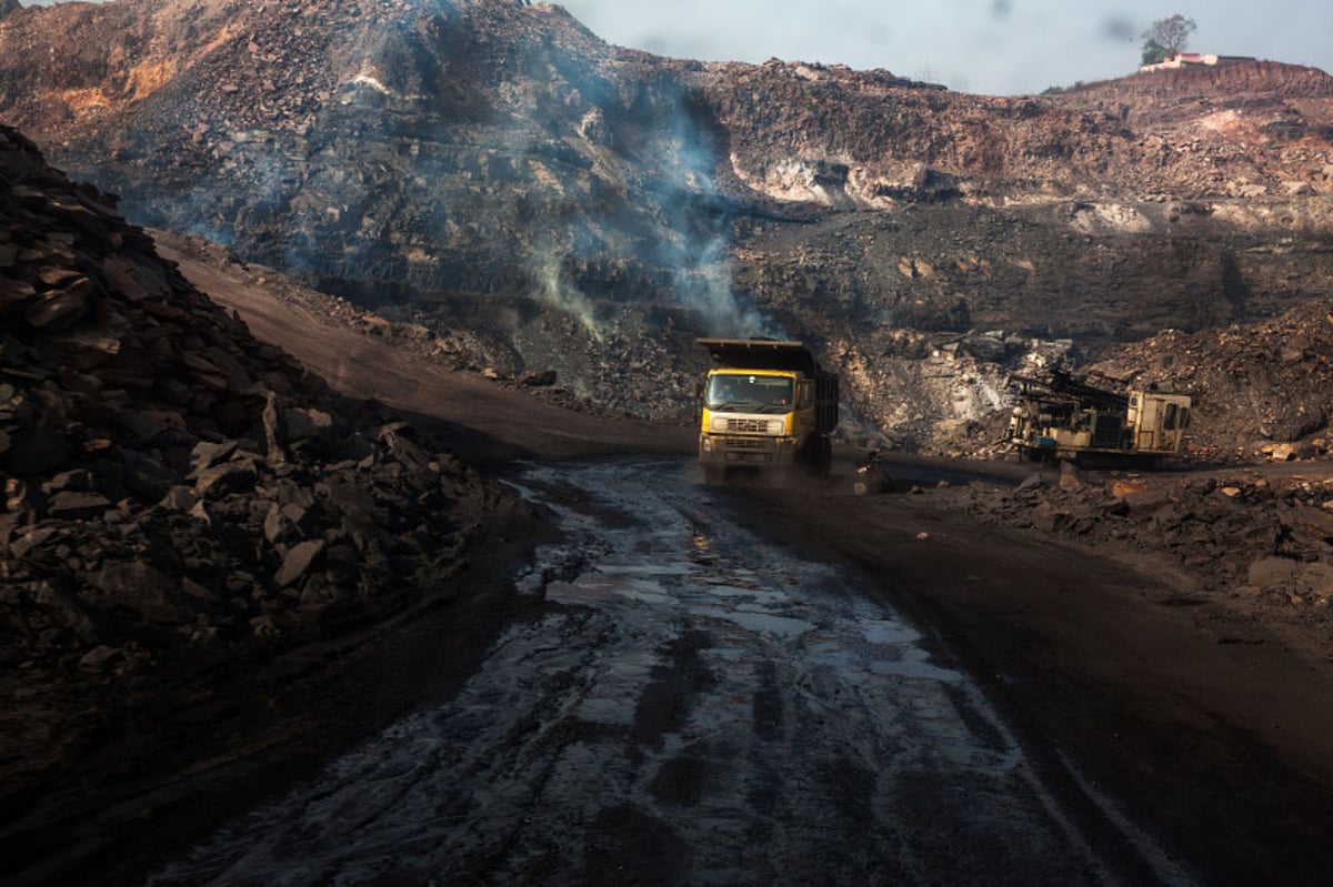 Flames break through the ground from coal fires that burn at an open cast coal mine in Jharia, Jharkhand. (Photographer: Sanjit Das/Bloomberg)