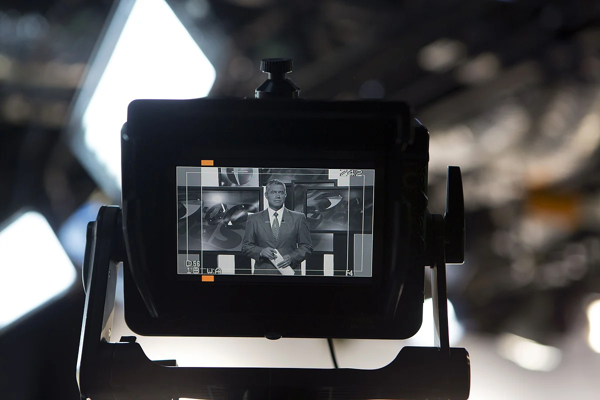 An anchor for a news channel, is seen on the monitor of a television camera. (Photographer: Susana Gonzalez/Bloomberg)