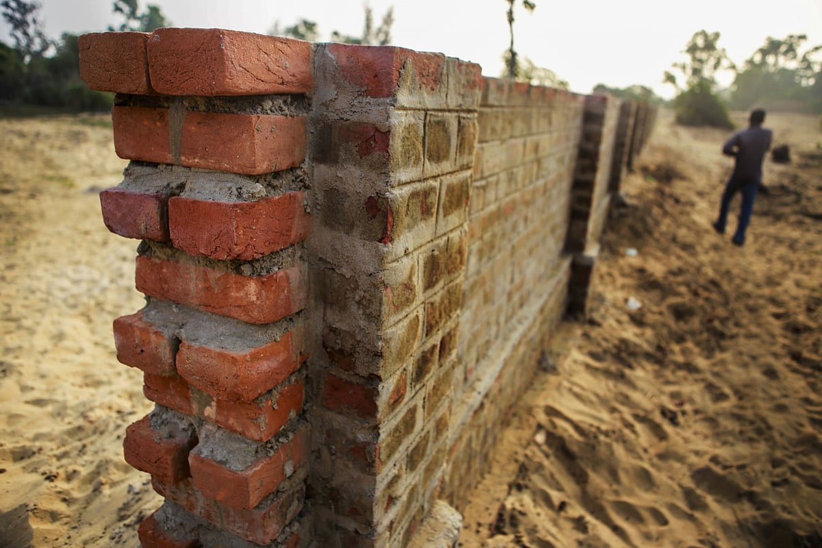 A perimeter wall stands under construction in Nuagaon, Odisha. (Photographer: Prashanth Vishwanathan/Bloomberg)