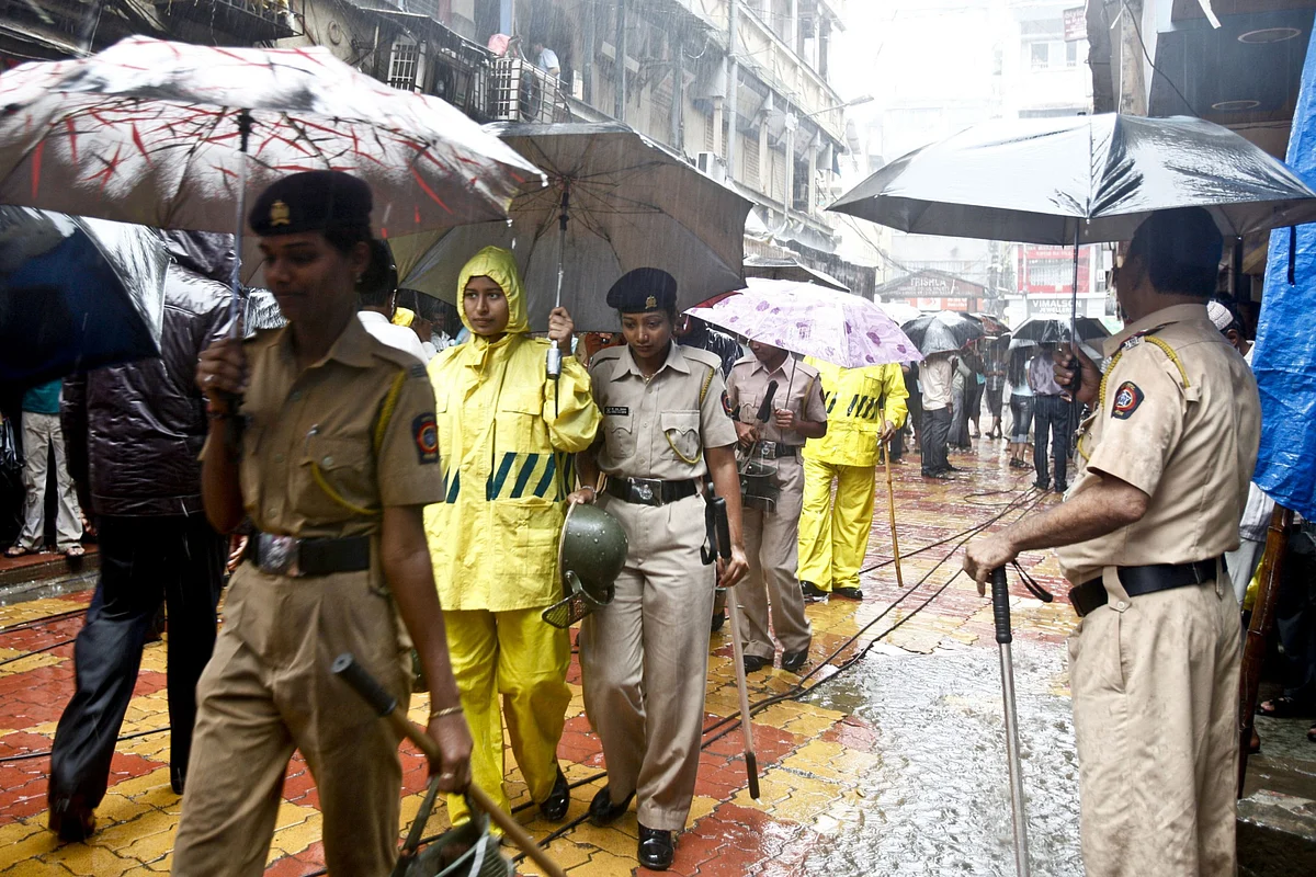 Police officers patrol the area of Zaveri Bazaar in Mumbai, on July 14, 2011, a day after three bombings in India’s financial capital. (Photographer: Kainaz Amaria/Bloomberg)