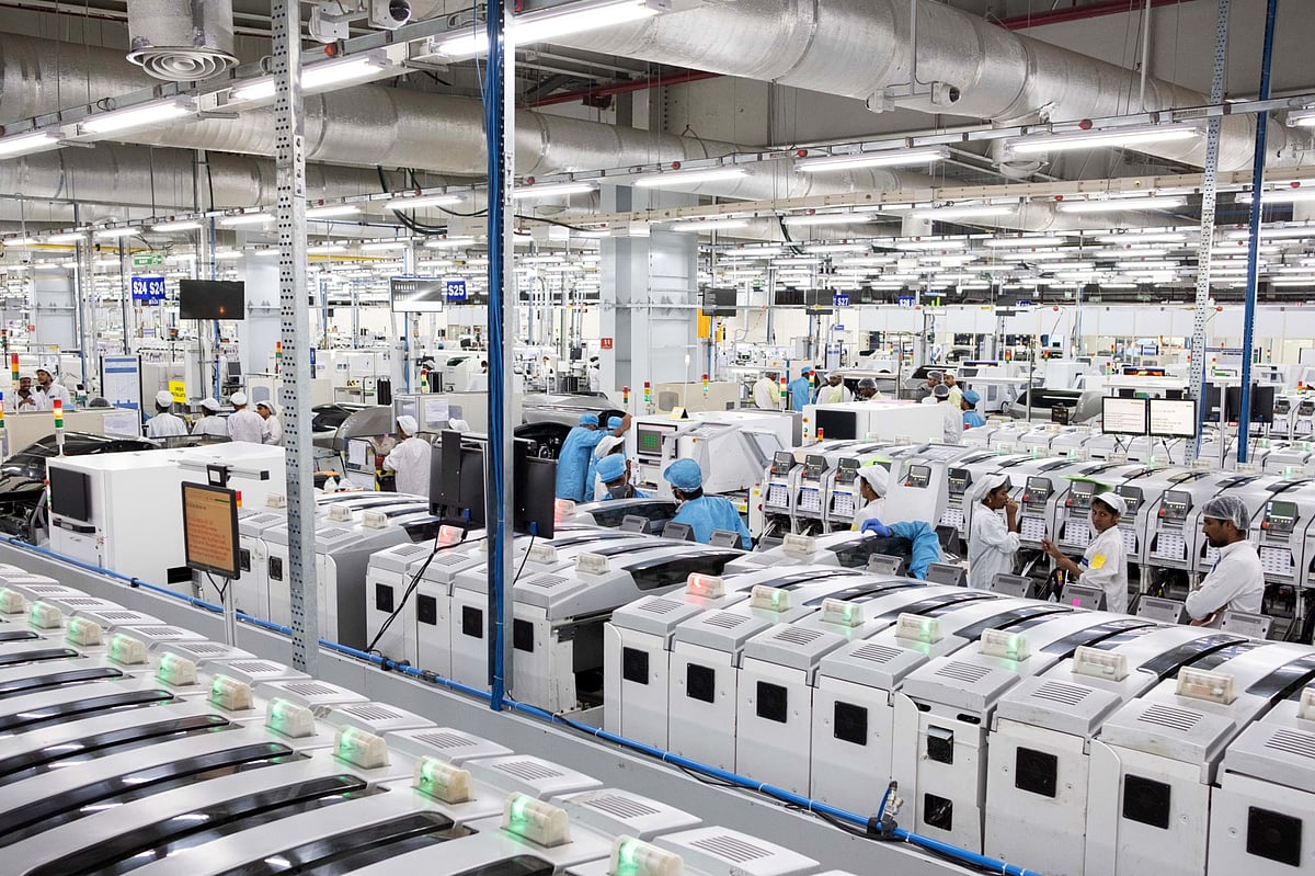 Employees work on an assembly line in the mobile phone plant of Rising Stars Mobile India Pvt., a unit of Foxconn Technology Co., in Sriperumbudur, Tamil Nadu, India. (Photographer: Karen Dias/Bloomberg)