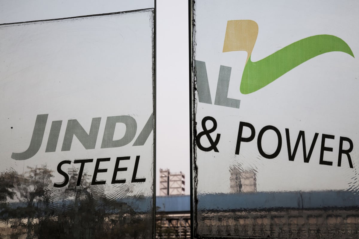 Signage for Jindal Steel &amp; Power Ltd. is displayed on glass screens at the Raigarh plant. (Photographer: Udit Kulshrestha/Bloomberg)