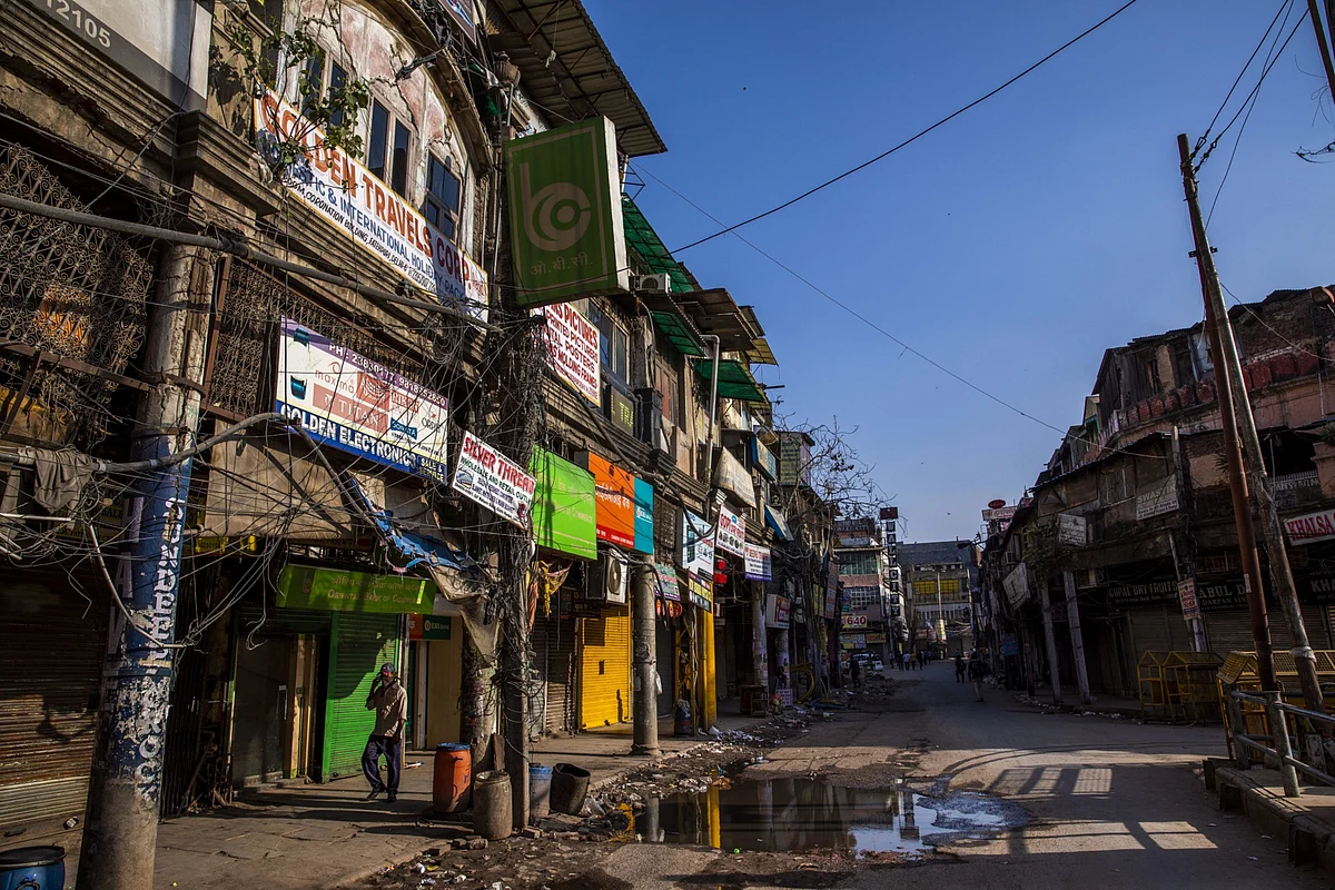 <div class="paragraphs"><p>A man walks past shuttered stores near the Khari Baoli spice market in Delhi, in March 2020. (Photographer: Prashanth Vishwanathan/Bloomberg)</p></div>