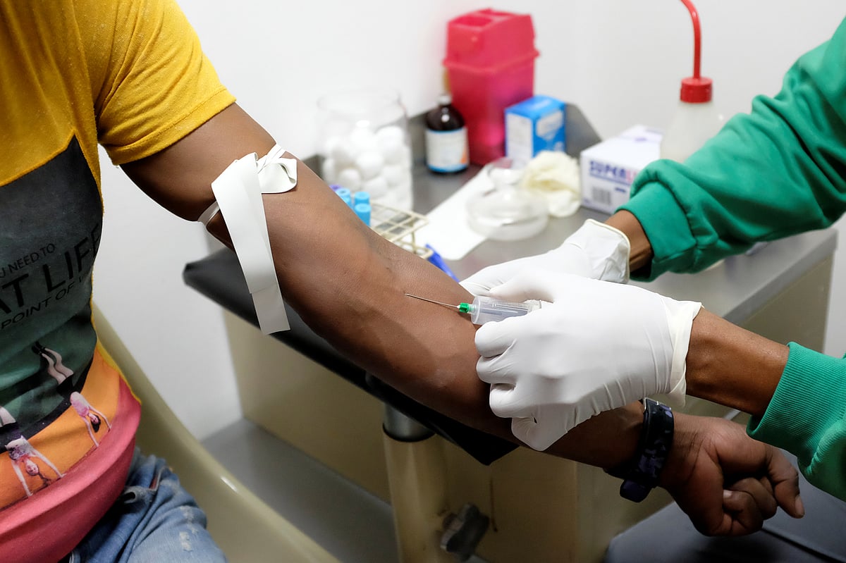 <div class="paragraphs"><p>A healthcare worker drawing a blood sample. (Source: Reuters)</p></div>