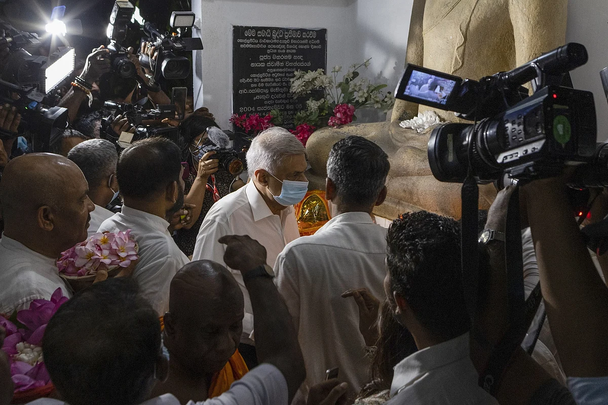 Ranil Wickremesinghe, center, visits a Buddhist temple to receive blessings in Colombo on May 12.Photographer: Buddhika Weerasinghe/Bloomberg