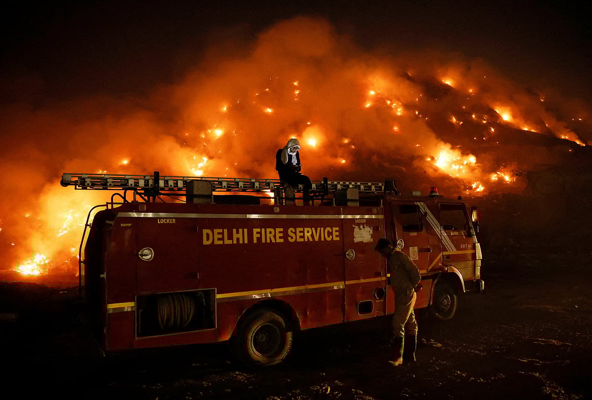<div class="paragraphs"><p>A firefighter uses his mobile phone as he sits on top of a fire truck. [REUTERS/Adnan Abidi]</p></div>