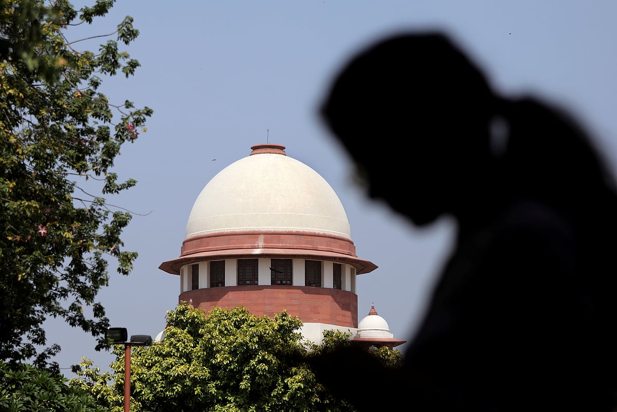 <div class="paragraphs"><p>A woman checks her mobile phone inside the premises of the Supreme Court in New Delhi. [REUTERS/Anushree Fadnavis]</p></div>