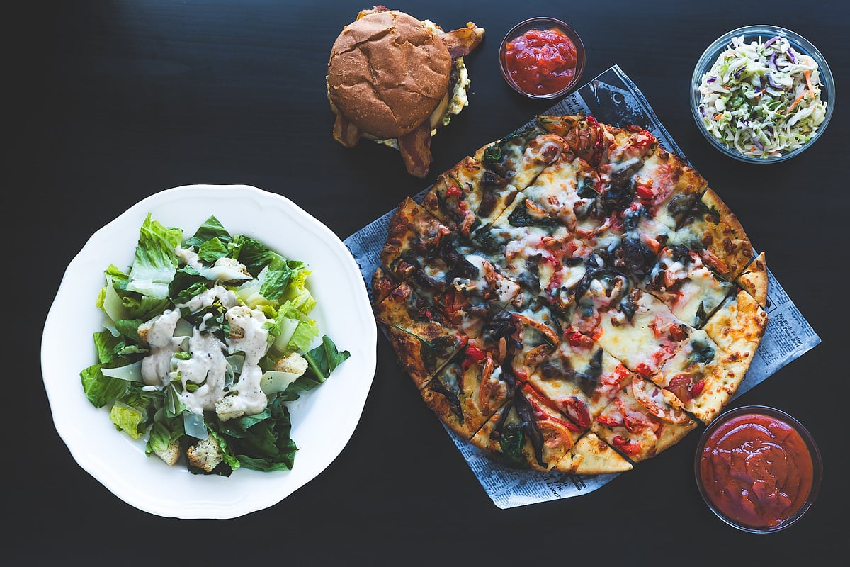 <div class="paragraphs"><p>Pizza, burgers, salads served on table. (Photo: Javier Quiroga/ Source: Unsplash)</p></div>
