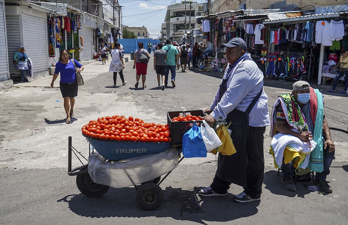 Street vendors at a local market in San Salvador, El Salvador. The nation has faced repeated slashing of its credit rating.Photographer: Armando Constanza/Getty Images