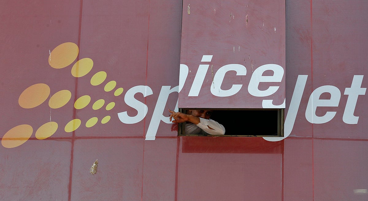 <div class="paragraphs"><p>A man looks out through a window with a SpiceJet ad. (Photo: Reuters/Amit Dave)</p></div>