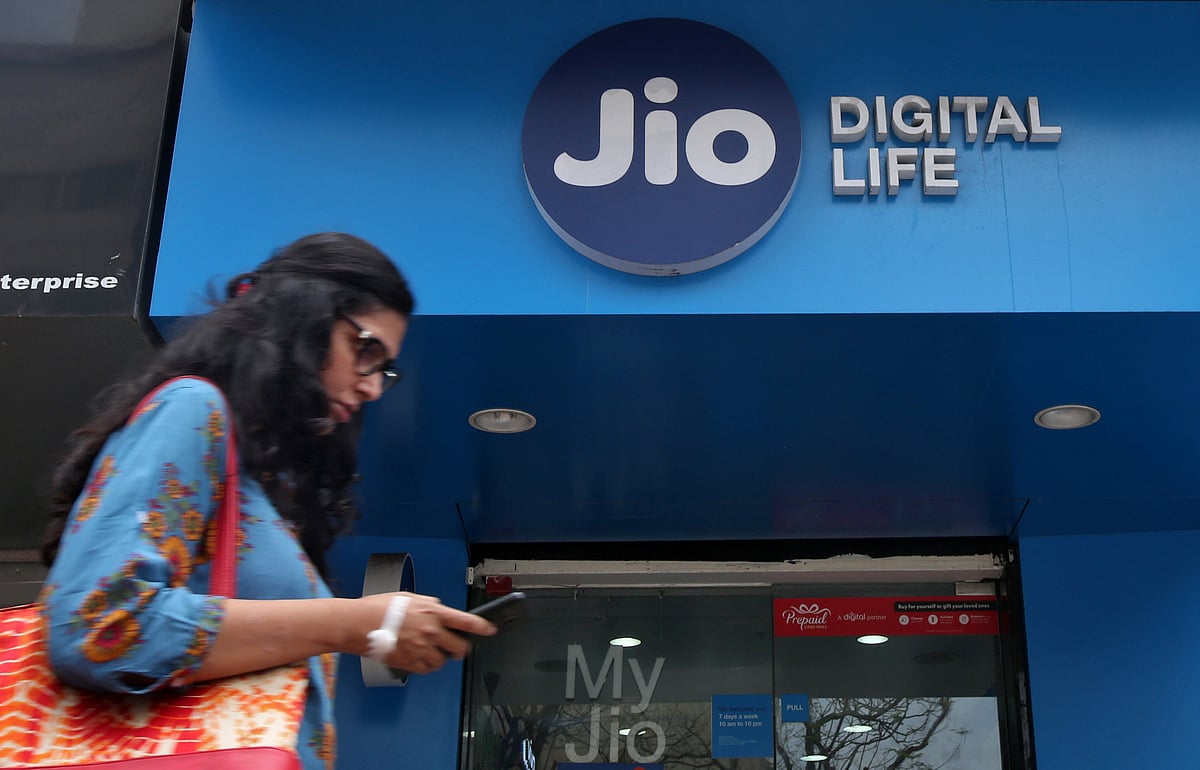 <div class="paragraphs"><p>A woman checks her mobile phone as she walks past a mobile store of Reliance Industries' Jio telecom unit in Mumbai, India.&nbsp; (Source: Reuters/Shailesh Andrade)</p></div>