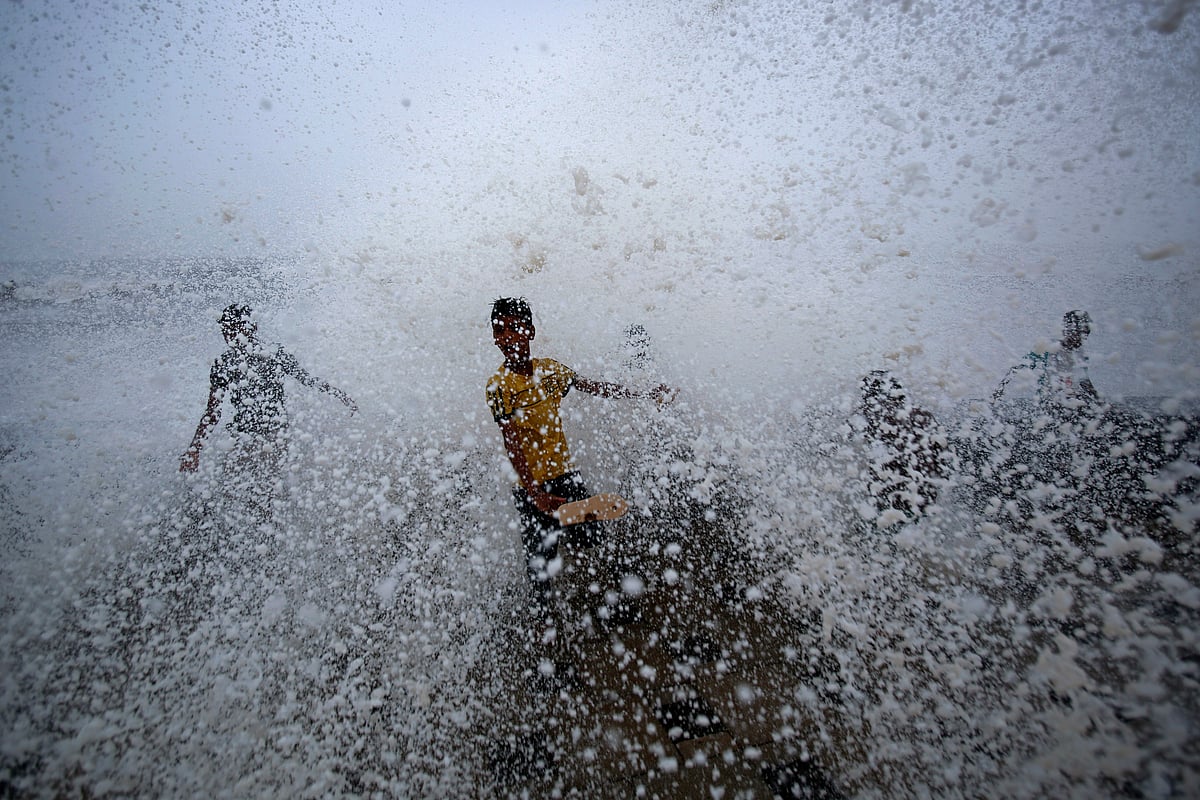 <div class="paragraphs"><p>Boys play at a sea wall as waves crash over it during a monsoon rain shower in Mumbai. (Photo: Vivek Prakash/Reuters)</p></div>