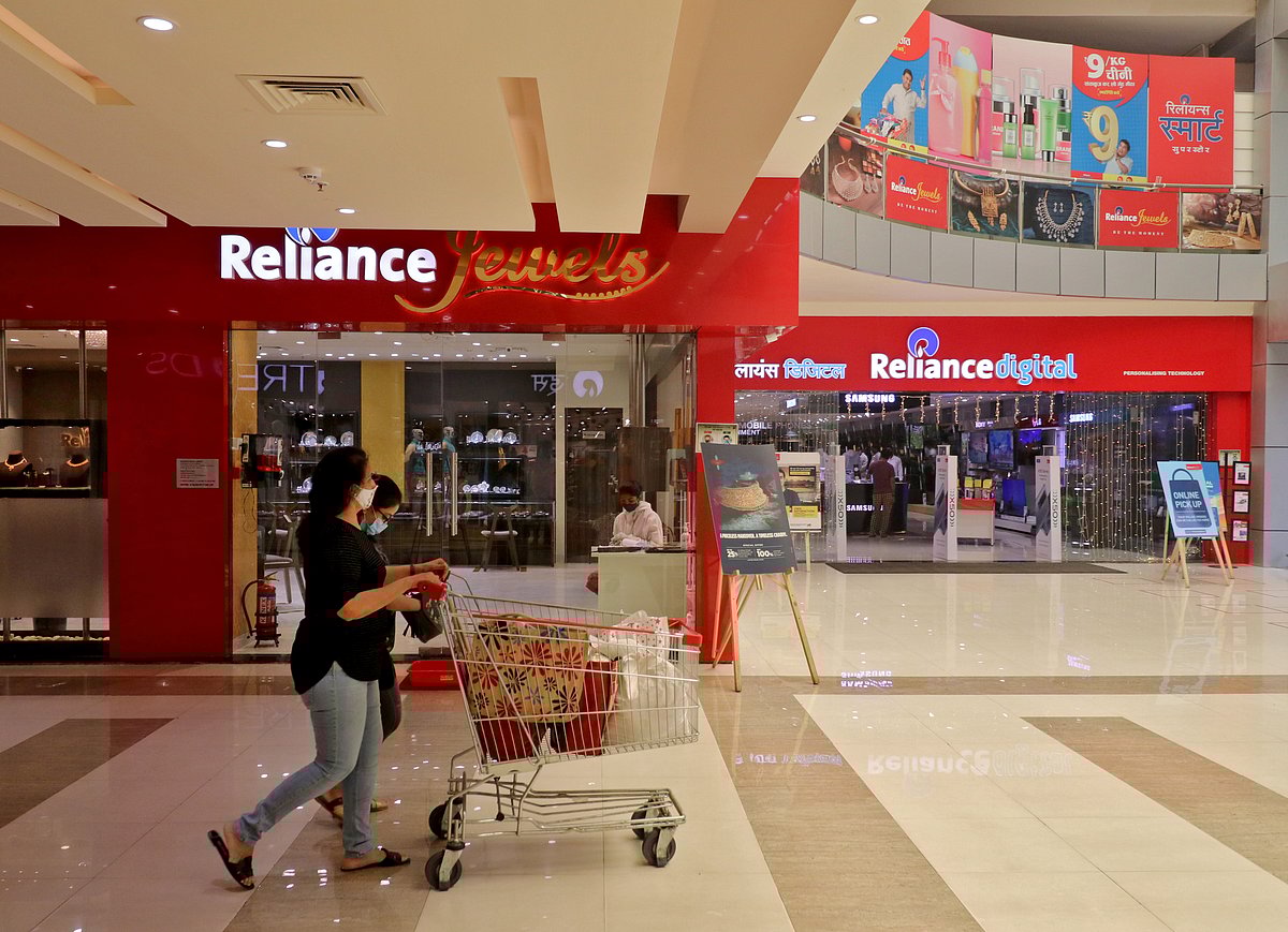<div class="paragraphs"><p>A customer pushes a trolley past a Reliance Retail store in Mumbai. (Photo: Niharika Kulkarni/Reuters)</p></div>