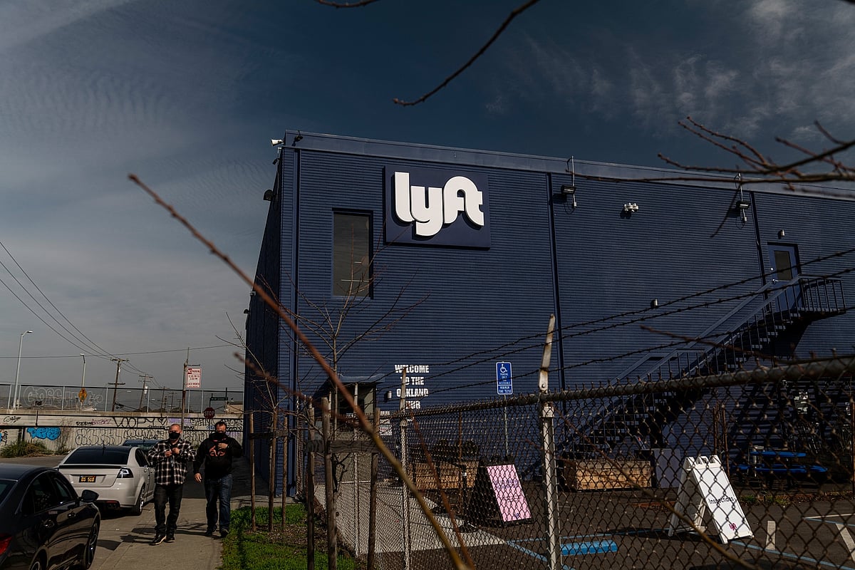 After freezing hiring, Lyft is planning to cut about 13% of staff.Photographer: David Paul Morris/Bloomberg