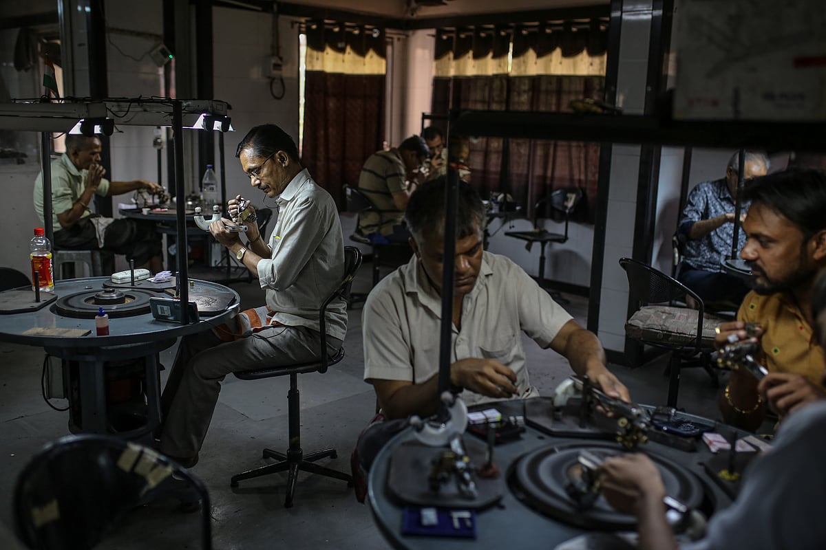 Employees inspect and polish diamonds at a workshop in Surat, Gujarat, India.Photographer: Dhiraj Singh/Bloomberg