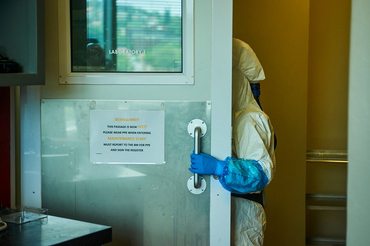 A technician wearing a full body protection suit enters a BSL-3 Covid-19 research laboratory at the African Health Research Institute in Durban, South Africa, in 2021.Photographer: Waldo Swiegers/Bloomberg