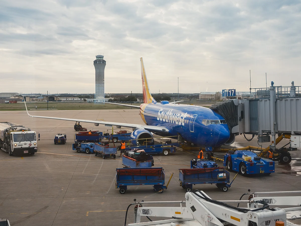 A Southwest aircraft at a gate in front of the air traffic control tower in Austin–Bergstrom International Airport.Photographer: Jordan Vonderhaar/Bloomberg
