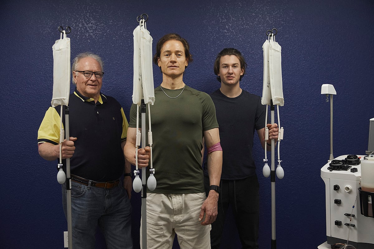 <div class="paragraphs"><p>Bryan Johnson (center), flanked by his father Richard and son Talmage during an infusion treatment.Courtesy: Bryan Johnson / Photographer: Magdalena Wosinska</p></div>