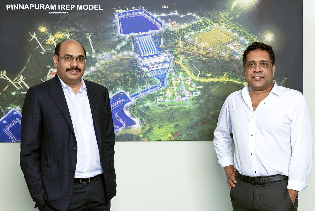 Kolli (left) and Chalamalasetty (right) at Greenko headquarters in Hyderabad. Behind them is a model of the Kurnool integrated renewable energy project.