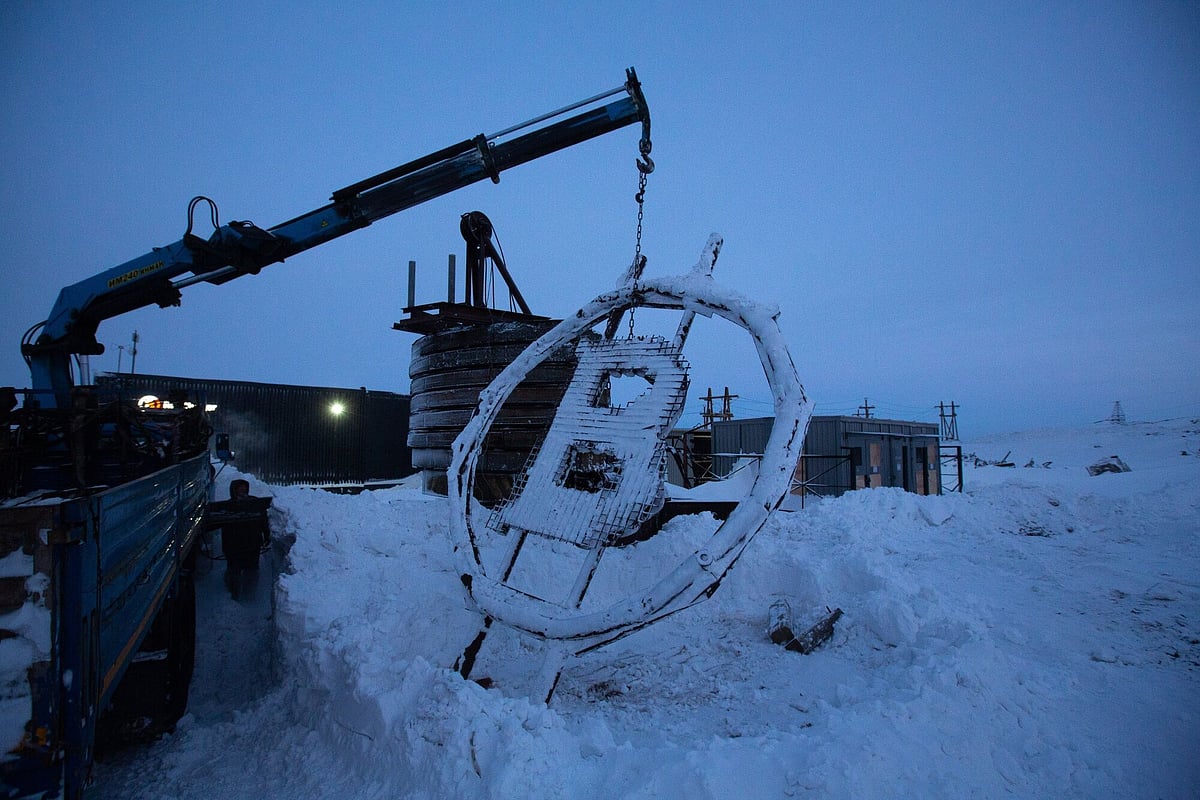 A crane arm lifts a bitcoin sculpture made from scrap metal as it is installed outside the BitCluster cryptocurrency mining farm in Norilsk, Russia, on Sunday, Dec. 20, 2020. Norilsk may soon be famous for a different type of mining — it now hosts the Arctic's first crypto farm for producing new Bitcoins. Photographer: Andrey Rudakov/Bloomberg